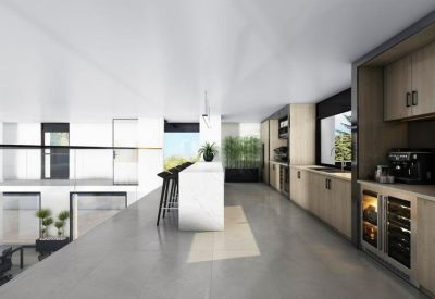 Bright communal kitchen area featuring light wood cabinetry and a white breakfast bar.