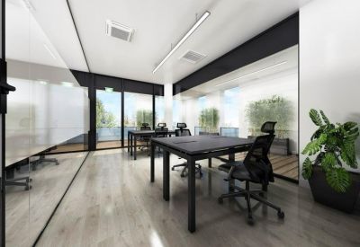Modern four-person office suite with black desks and wooden flooring.