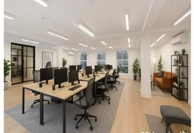 CGI layout of an open-plan office with wooden desks and ergonomic black chairs.