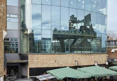 Portrait view of the glass-facade London Triangle building in Camden Lock Market.