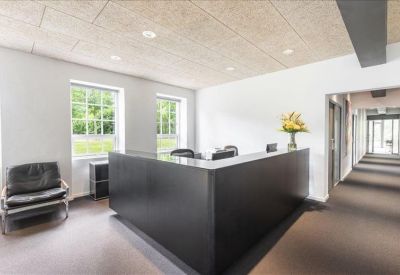 Sleek black reception desk in a bright lobby with large windows.