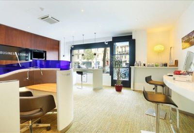 Modern reception lounge with a curved purple glass divider and stylish bar seating.