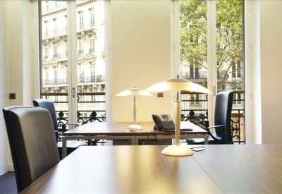 Bright private office featuring dark leather chairs and modern desk lamps.