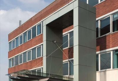 Close-up portrait of the modern grey portal entrance and glass canopy.