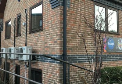 Cozy office area with colorful chairs and a desk.