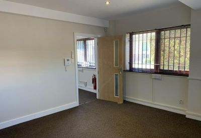 Open-plan office space with a window and neutral decor.