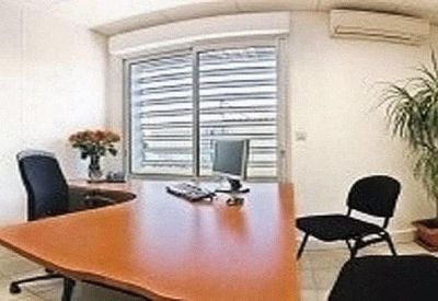 Private office with a curved desk and ergonomic chair