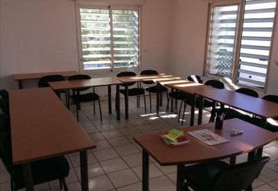 Meeting room with multiple tables and natural light