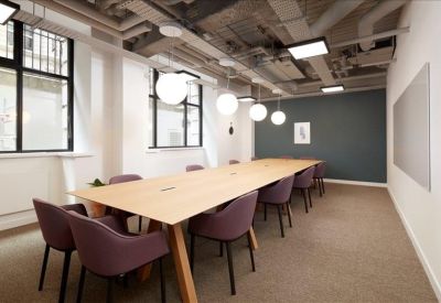 Conference room with long table and plush seating.