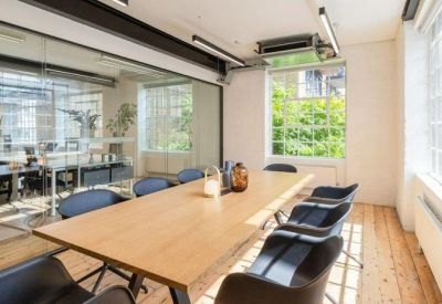 Contemporary meeting room with a long wooden table and glass partition wall