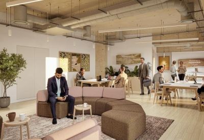 Bright lounge area featuring a curved modular sofa, soft lighting, and multiple breakout meeting tables.