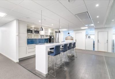 Modern wooden reception desk with indoor plants and integrated lighting.