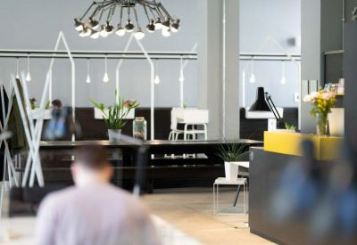Modern lounge area with designer lighting and a sleek reception desk.