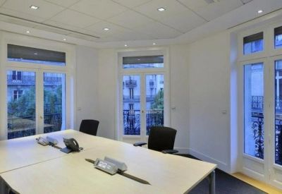Professional meeting room featuring a large table and elegant balcony views.