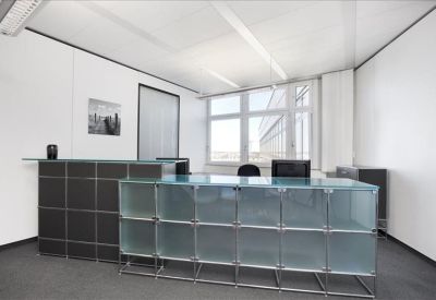 Modern reception area featuring a textured dark desk and frosted glass counters.