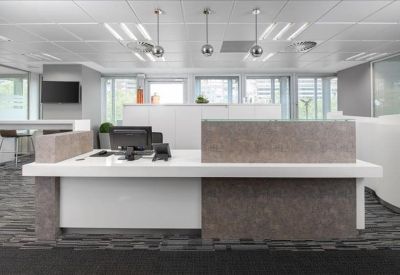 Bright reception desk with stone-textured panels and modern pendant lighting.