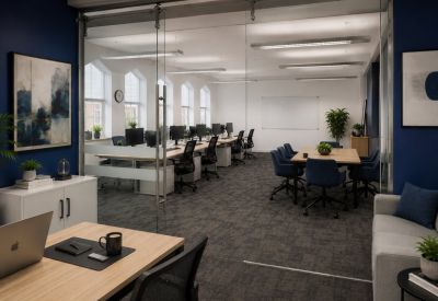 Glass-walled conference room with blue chairs and a white boardroom table.