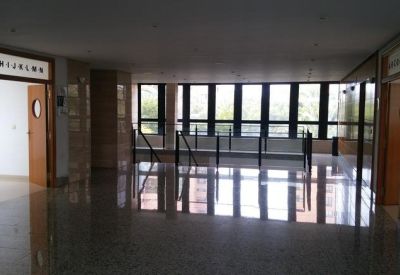 Large open lobby with polished reflective floors and a wall of windows.