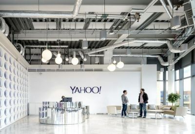 Bright reception lobby featuring a polished silver desk and large Yahoo branding.