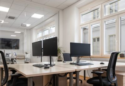 Open-plan workspace with modern desks and ergonomic chairs.
