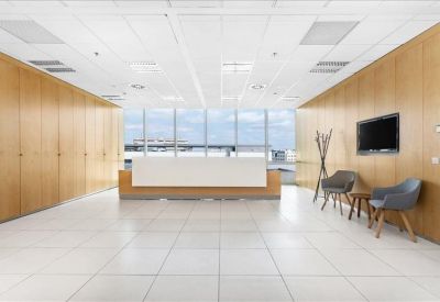 Spacious reception area with wood-paneled walls and a sleek white front desk.