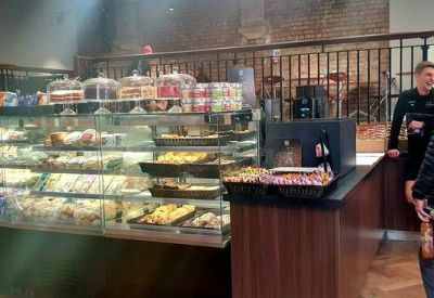 Cafe display counter filled with fresh sandwiches and treats.