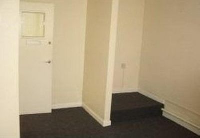 Private office space with a split-level floor and neutral walls.