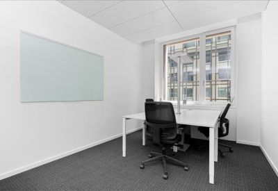 Private office featuring a large whiteboard and minimalist white desk.