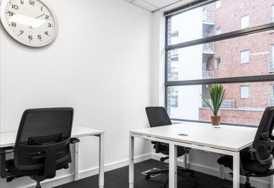 Two-person office suite with white desks and a wall-mounted clock.