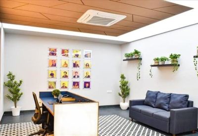 Modern private office at Ruhrallee 185 with a blue accent wall and large window.