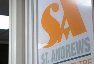Close-up of internal signage on a white panel with orange and grey branding.