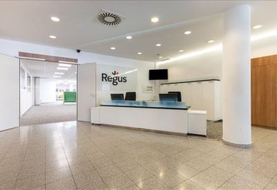 Professional reception area with a sleek white desk and branded signage.