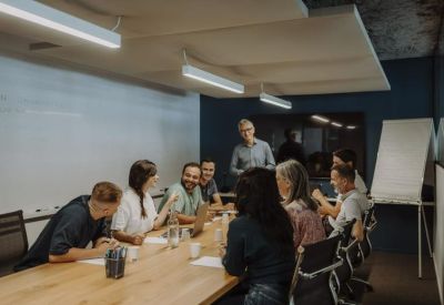 Professional meeting room with a long wooden table and modern lighting.
