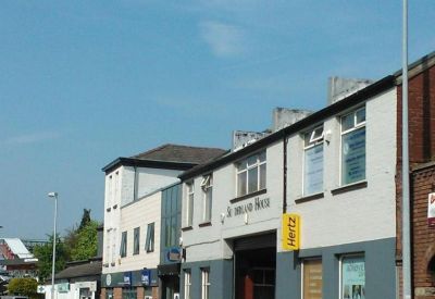 Exterior view of the white and grey facade of Sunderland House on a clear day.