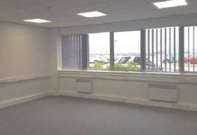 Spacious office area with integrated vertical blinds and recessed lighting.