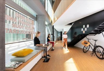 Symmetrical open-plan office layout with long wooden desks and integrated privacy screens.