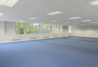 Bright, empty office suite with suspended ceilings and natural light.