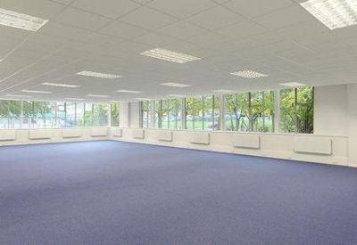 Large interior workspace with perimeter heating and rows of ceiling lights.