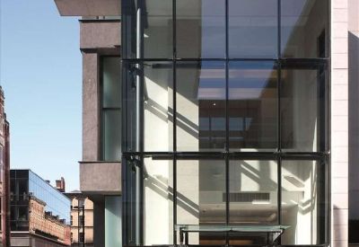 Exterior entrance of The Exchange, 3 New York Street, featuring a multi-story glass facade and modern stone columns.