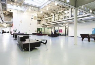 Bright open-plan atrium with a pool table and lounge seating.