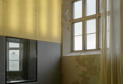 Interior room with warm light panels, high windows, and sheer curtains.