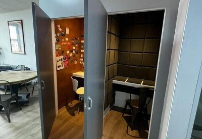 Pair of private soundproof phone booths with On Air signs above the doors.