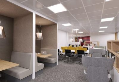 Breakout area with private booths and comfortable grey lounge seating.