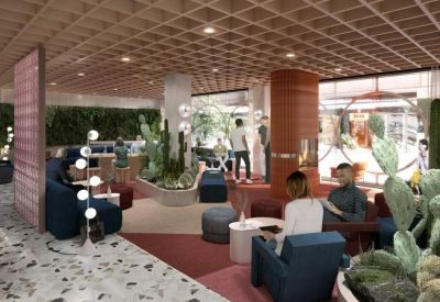Vibrant lobby lounge with desert plants, terrazzo flooring, and plush seating.
