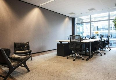 Spacious communal coworking area with workstations and comfortable lounge seating.
