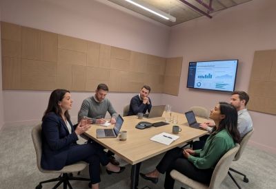 Professional five-person meeting room with a large screen and wood-panelled walls.