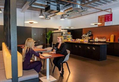 In-house café and breakout area with a dark service counter and comfortable booth seating.