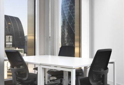 Modern workspace with height-adjustable white desks and views of The Gherkin through floor-to-ceiling windows.