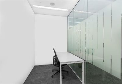 Communal break area with a coffee machine, white counters, and lime green booth seating.