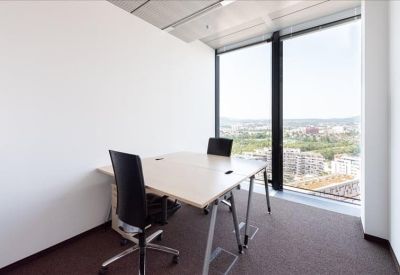 Compact two-person private office with expansive window views.